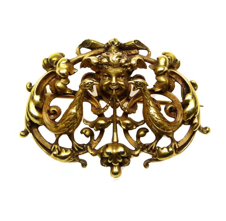 19th century openwork gold maskhead and scroll cartouche brooch by Wiese.